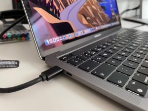 A laptop with the USB-C cable connected.